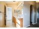 Bathroom featuring a double sink vanity, a shower, and an arched hallway at 4191 Sw 110Th Ln, Ocala, FL 34476