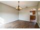 Inviting dining room featuring wood floors and a stylish chandelier at 4191 Sw 110Th Ln, Ocala, FL 34476