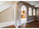 Hallway with tile and wood flooring, arched doorways, and views into the kitchen and other living spaces at 4191 Sw 110Th Ln, Ocala, FL 34476