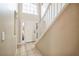 Bright foyer with tile floors, white staircase, and a front door with glass panels allowing natural light to flow in at 4191 Sw 110Th Ln, Ocala, FL 34476