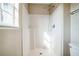 Bright shower with a window, white tiling, and modern fixtures at 4191 Sw 110Th Ln, Ocala, FL 34476