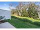 View of the green backyard with mature trees and privacy fence at 4653 Sparkling Shell Ave, Kissimmee, FL 34746