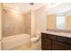 Bright bathroom with a tub, shower and a granite-topped vanity at 4653 Sparkling Shell Ave, Kissimmee, FL 34746