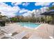 Community pool with lounge chairs and manicured landscaping at 4653 Sparkling Shell Ave, Kissimmee, FL 34746