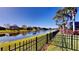 View of the fenced backyard with a pond view at 472 Huntington Pines Dr, Ocoee, FL 34761