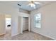 Carpeted bedroom with ceiling fan and a closet with shelving at 472 Huntington Pines Dr, Ocoee, FL 34761