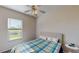 Cozy bedroom with a comfortable bed, window view, and a ceiling fan at 472 Huntington Pines Dr, Ocoee, FL 34761