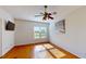 Bright bedroom with hardwood floors, ceiling fan, and large window at 472 Huntington Pines Dr, Ocoee, FL 34761