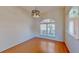 Bright dining room featuring wood floors, arched window, and contemporary chandelier at 472 Huntington Pines Dr, Ocoee, FL 34761