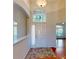 Bright foyer featuring tile and hardwood floors, a decorative window, and a view into other rooms at 472 Huntington Pines Dr, Ocoee, FL 34761