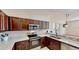 Spacious kitchen featuring stainless steel appliances, granite countertops and sleek dark cabinets at 472 Huntington Pines Dr, Ocoee, FL 34761