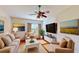 Cozy living room featuring comfortable seating, a ceiling fan, and a large window with natural light at 472 Huntington Pines Dr, Ocoee, FL 34761