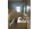 Bathroom featuring a sink, toilet, and bathtub with window and mirror at 491 Grandview Ave, Ormond Beach, FL 32176