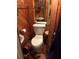 Bathroom needing maintenance with wood paneling and fixtures at 491 Grandview Ave, Ormond Beach, FL 32176