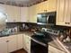 Picture of kitchen featuring tile backsplash, stainless steel microwave, and dark countertops at 491 Grandview Ave, Ormond Beach, FL 32176