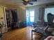 View of messy living room featuring hardwood floors and blue front door at 491 Grandview Ave, Ormond Beach, FL 32176