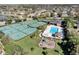 Aerial view of a well-appointed community pool, tennis and basketball courts, and a playground, enhancing the lifestyle at 515 Mickleton Loop, Ocoee, FL 34761