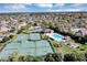 An aerial view showcasing tennis and basketball courts, a pool, and a playground within the residential community at 515 Mickleton Loop, Ocoee, FL 34761