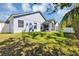 Charming backyard with a lush green lawn, showcasing the home's exterior and screened patio at 515 Mickleton Loop, Ocoee, FL 34761