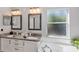 Bright bathroom featuring double sinks with granite countertops, soaking tub, and natural light at 515 Mickleton Loop, Ocoee, FL 34761