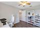 Bedroom with a desk and chair, natural light through the window, and ample space to relax at 515 Mickleton Loop, Ocoee, FL 34761