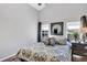 Bright bedroom with vaulted ceiling, large windows, and decorative mirror above the bed at 515 Mickleton Loop, Ocoee, FL 34761