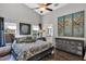 Bright bedroom with vaulted ceiling, large windows, decorative mirror and dresser with art at 515 Mickleton Loop, Ocoee, FL 34761