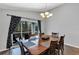 Dining room featuring a wooden table, six chairs, and sliding doors to a covered patio at 515 Mickleton Loop, Ocoee, FL 34761