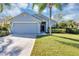 Charming single-story home features a well-manicured lawn and an attached two-car garage at 515 Mickleton Loop, Ocoee, FL 34761