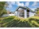 Exterior showcasing the screened patio with outdoor seating, surrounded by lush greenery at 515 Mickleton Loop, Ocoee, FL 34761