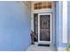 View of front door with decorative glass and a charming vintage-style decoration at 515 Mickleton Loop, Ocoee, FL 34761