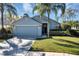 Traditional-style home with a two-car garage, green lawn, and tasteful landscaping at 515 Mickleton Loop, Ocoee, FL 34761