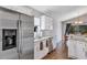 Bright kitchen featuring stainless steel appliances, granite countertops, and a view of the dining area at 515 Mickleton Loop, Ocoee, FL 34761