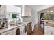 Well-lit kitchen featuring granite countertops, stainless steel appliances, and a double sink under a window at 515 Mickleton Loop, Ocoee, FL 34761