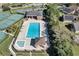 Aerial view of a community pool, tennis courts, clubhouse, and landscaping at 515 Mickleton Loop, Ocoee, FL 34761