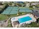 Overhead angle of a pool and playground alongside tennis and basketball courts in a community at 515 Mickleton Loop, Ocoee, FL 34761