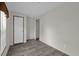 The bright bedroom features gray wood-look flooring, neutral walls, and a white door for a clean aesthetic at 5227 Orange Ave, Port Orange, FL 32127