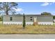 Charming single-story home with new light-green siding, white trim, and a well-manicured front lawn at 5227 Orange Ave, Port Orange, FL 32127