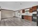 The open-concept kitchen flows into a living space, featuring wood-look floors and bright walls at 5227 Orange Ave, Port Orange, FL 32127