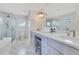 Bright bathroom with double sinks, shower, and tiled floors at 5238 Baskin St, Orlando, FL 32814