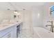 Elegant bathroom with double sinks, and a large soaking tub at 5238 Baskin St, Orlando, FL 32814