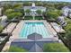 Aerial view of a community pool and clubhouse with surrounding trees and ample lounge seating at 5238 Baskin St, Orlando, FL 32814