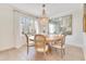 Bright dining area featuring a beaded chandelier, a round wooden table, and elegant decor at 5238 Baskin St, Orlando, FL 32814