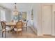 Bright dining area featuring a beaded chandelier, a round wooden table with chairs, and luxury decor at 5238 Baskin St, Orlando, FL 32814