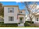 Charming two-story home with blue shutters and an inviting covered entry and a well manicured front lawn at 5238 Baskin St, Orlando, FL 32814