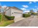 Spacious garage with a paved driveway, tidy hedges, and a well-maintained lawn at 5238 Baskin St, Orlando, FL 32814