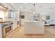 Modern kitchen featuring stainless steel appliances, a large island with a sink, pendant lighting, and hardwood floors at 5238 Baskin St, Orlando, FL 32814