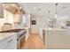 Bright kitchen featuring stainless steel appliances, a large island with seating, and white cabinets with gold hardware at 5238 Baskin St, Orlando, FL 32814