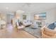 Bright living room featuring hardwood floors, stylish seating, and a coastal-themed TV display with staircase to the side at 5238 Baskin St, Orlando, FL 32814