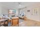 Inviting living room featuring hardwood floors, stylish seating, and a coastal-themed TV display, complemented by bright lighting at 5238 Baskin St, Orlando, FL 32814